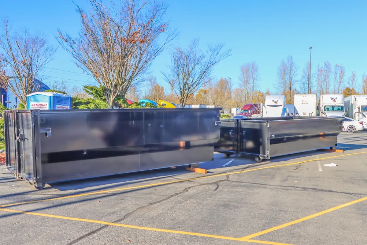 Professional dumpster rental service with roll-off container on residential driveway in Upper Gwynedd